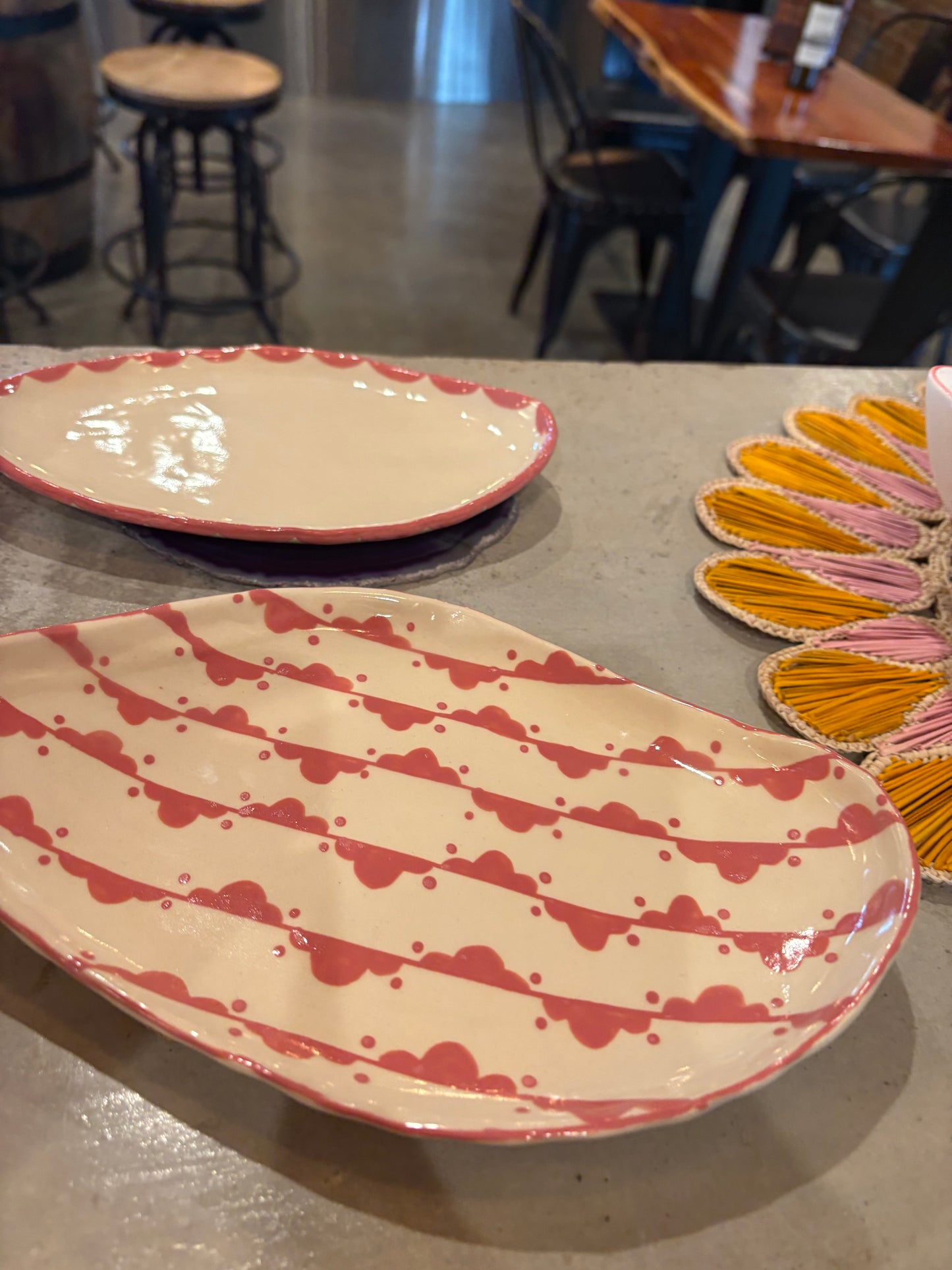 Handmade Pink Freeform Pottery Dish with pink design around the rim
