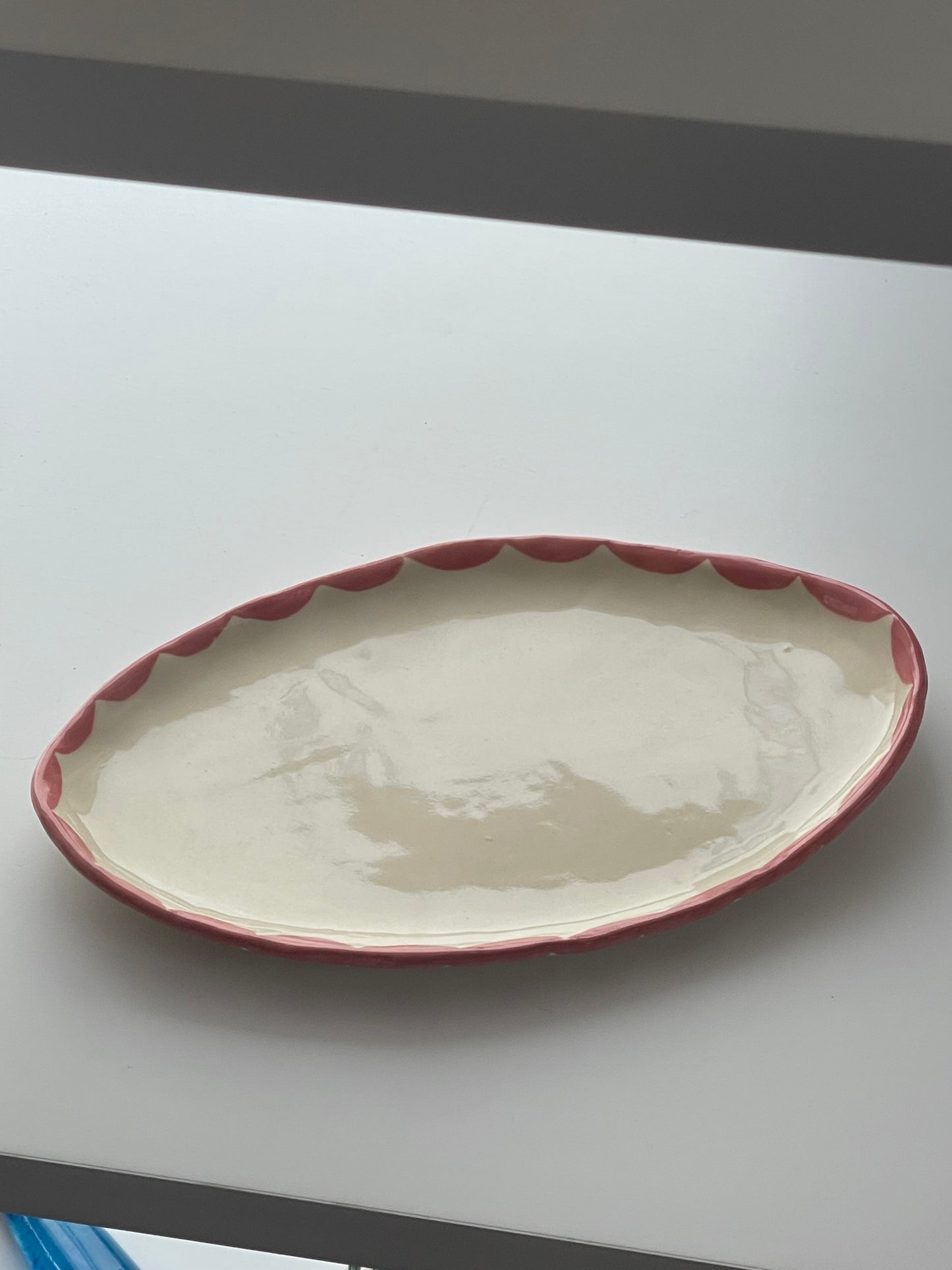 Handmade Pink Freeform Pottery Dish with pink design around the rim