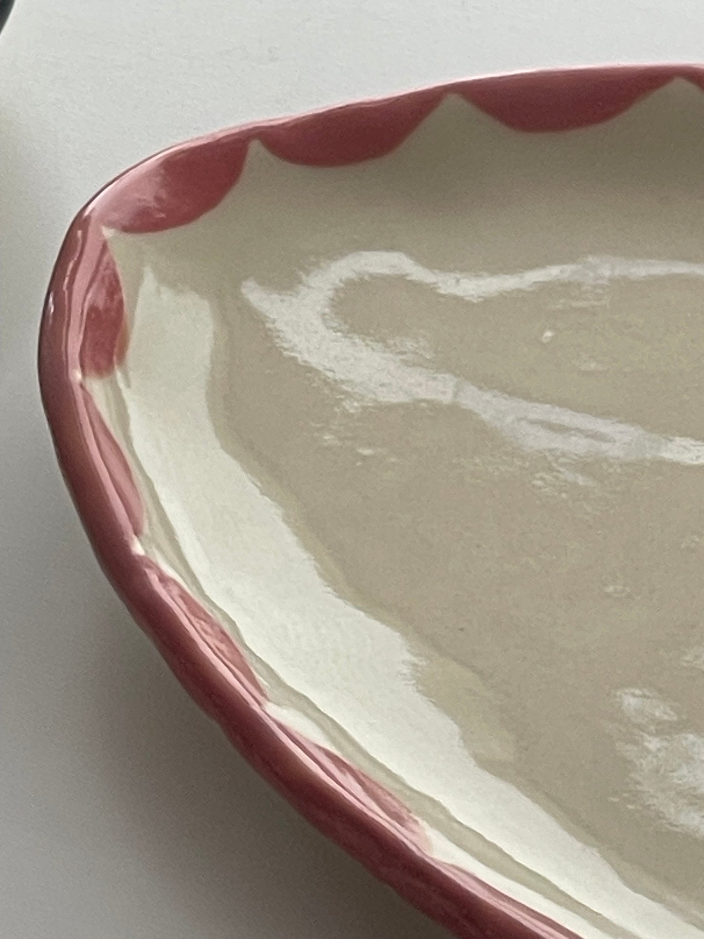 Handmade Pink Freeform Pottery Dish with pink design around the rim
